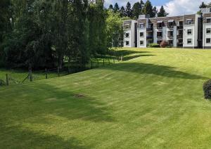 a large grassy yard in front of a building at Gleneagles Country Apartments in Auchterarder