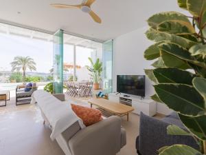 a living room with a couch and a tv at Pasitoblanco Porto Mare 44 Seaview Villa private heated pool in Pasito Blanco