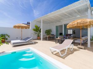 a villa with a swimming pool and a patio at Pasitoblanco Porto Mare 44 Seaview Villa private heated pool in Pasito Blanco +36 photos