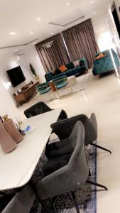 a living room with a white table and a couch at Lilly court estate area 11 apartment in Abuja