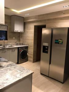 a kitchen with a stainless steel refrigerator at Lilly court estate area 11 apartment in Abuja