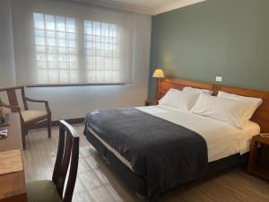 Rúm í herbergi á Almasur Punta Arenas