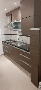 a kitchen with a sink and a stove in it at Gutem in Mar del Plata