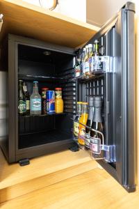 a refrigerator filled with lots of bottles of alcohol at Kipperi Kodumajutus in Lihula