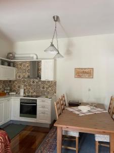 a kitchen with a wooden table and a dining room at Stymfalia Cozy Village Guesthouse in Kartérion