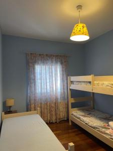 a bedroom with two bunk beds and a window at Stymfalia Cozy Village Guesthouse in Kartérion
