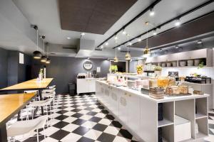 a restaurant with a black and white checkered floor at Best Western Princess Hotel in Norrköping