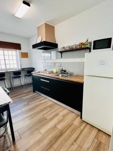 a kitchen with a white refrigerator and a wooden floor at Stay on Top Old Town in Lagos