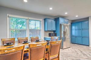 uma cozinha com armários azuis, uma mesa e um frigorífico em Lovely Lubbock Home with Furnished Patio and Yard em Lubbock