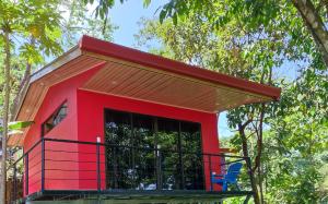 a red tree house with a red roof at Villas In Sueño Private Jungle Hotel in Manuel Antonio