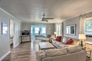 a living room with a couch and a tv at Lakefront Cottage with Fishing and Private Yard! in Port Clinton