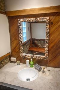 a bathroom with a sink and a mirror at Vistamar Guest House in Ayampe