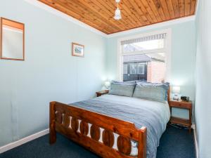 a bedroom with a bed with a wooden ceiling at Meadowsweet in Skegness
