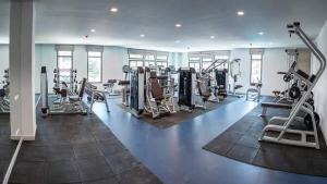 a gym with several treadmills and machines at Brand New 1Bdr Condo! 5 minutes from Famous Walking Street! in Pattaya South
