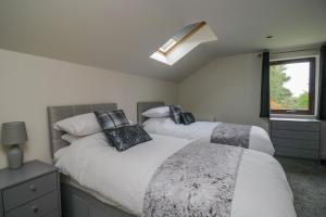 a bedroom with two beds and a window at The Annexe, Melbourne House in Penrith
