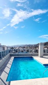 a swimming pool on the roof of a building at II Opera Towers Villa Carlos Paz in Villa Carlos Paz