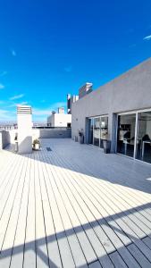a large patio on the roof of a building at II Opera Towers Villa Carlos Paz in Villa Carlos Paz