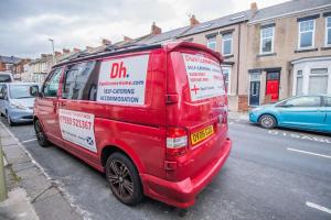a red van parked on the side of a street at Dwellcome Home Ltd 2 Bedroom 3 Bed South Shields Apartment - see our site for assurance in South Shields