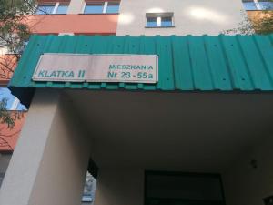 a sign on top of a building with a green roof at Alterra Apartment,13 legionowa street, flat, mieszkanie 41 in Białystok