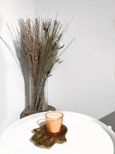 a candle sitting on a table with a vase at Eine schöne Wohnung im Herzen von Basel. in Basel