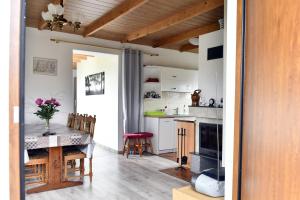 a kitchen and dining room with a table and chairs at Wczasy u Gospodarza na Kaszubach in Kistowko