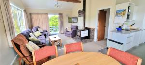 a living room with a couch and a table at Coromandel Coast Haven in Tapu +3 photos