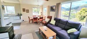 a living room with a couch and a table at Coromandel Coast Haven in Tapu