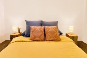 a bed with two candles on top of it at Dune Ten by Kingscliff Accommodation in Fingal Head