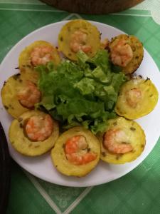 a plate of food with shrimp and lettuce on a table at Homestay Ngoc Sang in Vĩnh Long