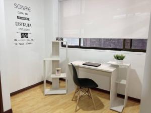 a white desk with a chair in a room at Lovely 1 bedroom apartment in Manizales +4 photos