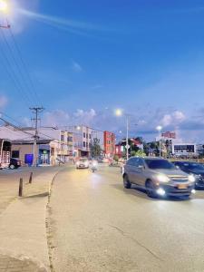 a group of cars driving down a city street at Lovely 1 bedroom apartment in Manizales