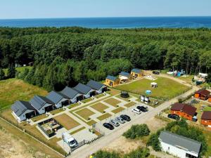 an aerial view of a farm with a parking lot at Cottages close to the sea, Wicie near Jaros awiec in Wicie