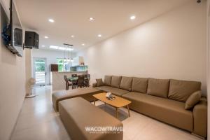 a living room with a couch and a table at SMilE WAVE in Xiaoliuqiu