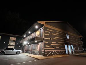 a car parked in front of a building at night at Rosewood Garden in Wisconsin Dells