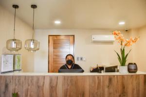 a man sitting at a counter in an office at Island Princess Resort & Spa Boracay in Boracay