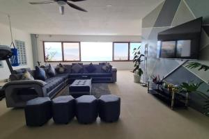 a living room with a couch and a table at Beachfront Vacation Villa with Infinity Pool in Batangas City