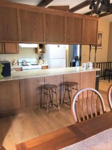 a kitchen with a counter and stools in a room at Yosemite Haven @ Pine Mountain Lake. Dog Friendly! in Groveland