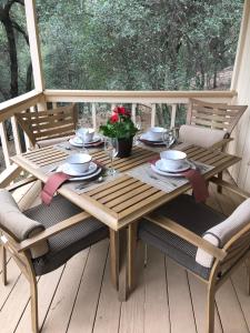 a wooden table and chairs on a deck at Yosemite Haven @ Pine Mountain Lake. Dog Friendly! in Groveland