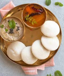 a plate of food with a bowl of dip and cookies at Zeus Bungalow in Kotagiri