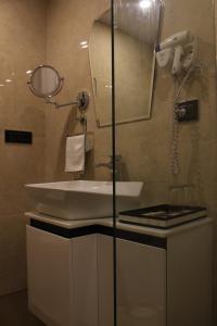 y baño con lavabo y espejo. en Mango Hotels Vijayawada, en Vijayawāda