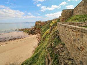 a view of a beach next to a retaining wall at Grand Sea View in North Shields