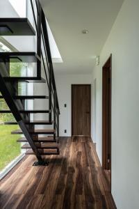 a staircase in a house with wood flooring at Furano Peak in Furano