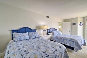 een slaapkamer met 2 bedden en blauwe dekbedden bij Luxury Oceanfront Condo in NMB with Resort Amenities in Myrtle Beach +30 foto's