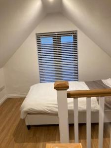 a white bedroom with a bed and a window at Burren 1 Bed Detached Guesthouse in Galway