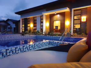 a view of a hotel pool at night at Goichi Resort in Dipaculao