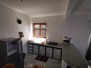 a kitchen with a counter top and a window at Résidence Oak in Petite Rivière