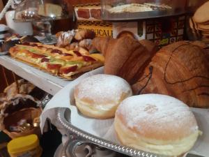 deux beignets sur un comptoir avec du pain et des viennoiseries dans l'établissement City View Pescara B&B, à Pescara