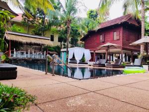 a house with a swimming pool in front of a house at Apsara Greenland Boutique Villa & Resort in Siem Reap