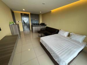 a hotel room with a bed and a kitchen at Studio Suite Genting Highland 33A in Genting Highlands