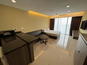 a hotel room with a bed and a desk in it at Studio Suite Genting Highland 33A in Genting Highlands